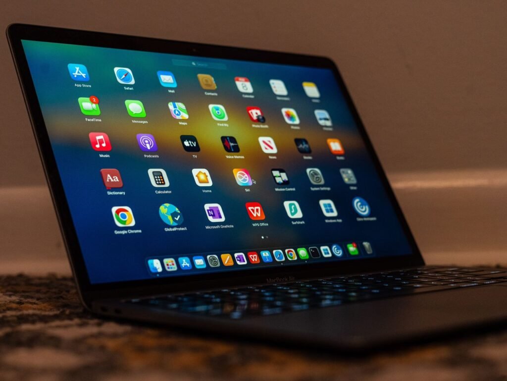 pexels-photo-30623336-30623336 Close-up of a laptop screen showing various applications and colorful icons.
